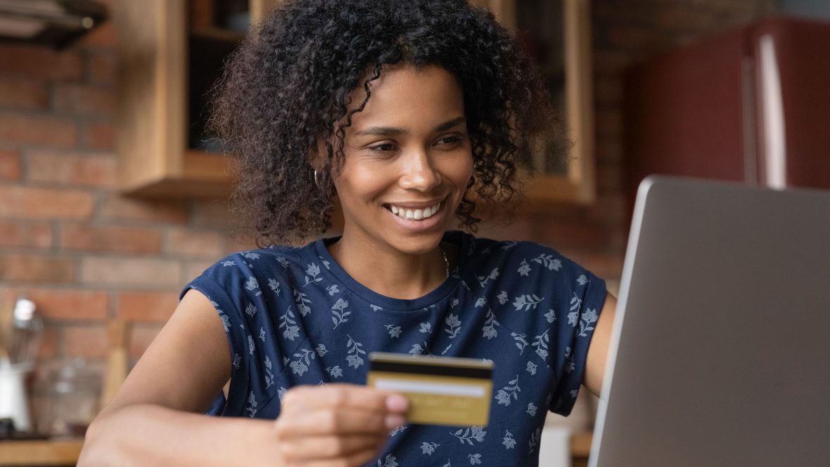 Woman with credit card at laptop